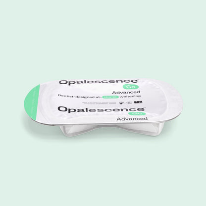 Opalescence Go Advanced 15% Prefilled Whitening Trays in a single-use sealed package on a light mint green background.
