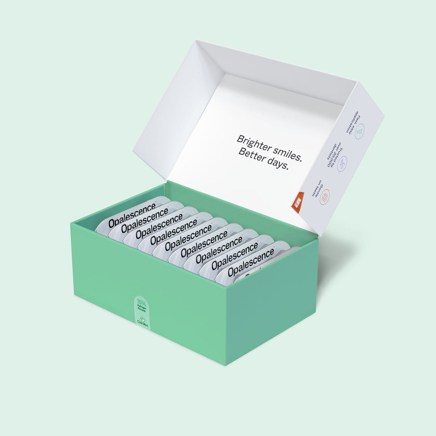 Open Opalescence Go Advanced 15% Prefilled Whitening Trays box with individually packaged whitening trays neatly arranged inside on a light mint green background.