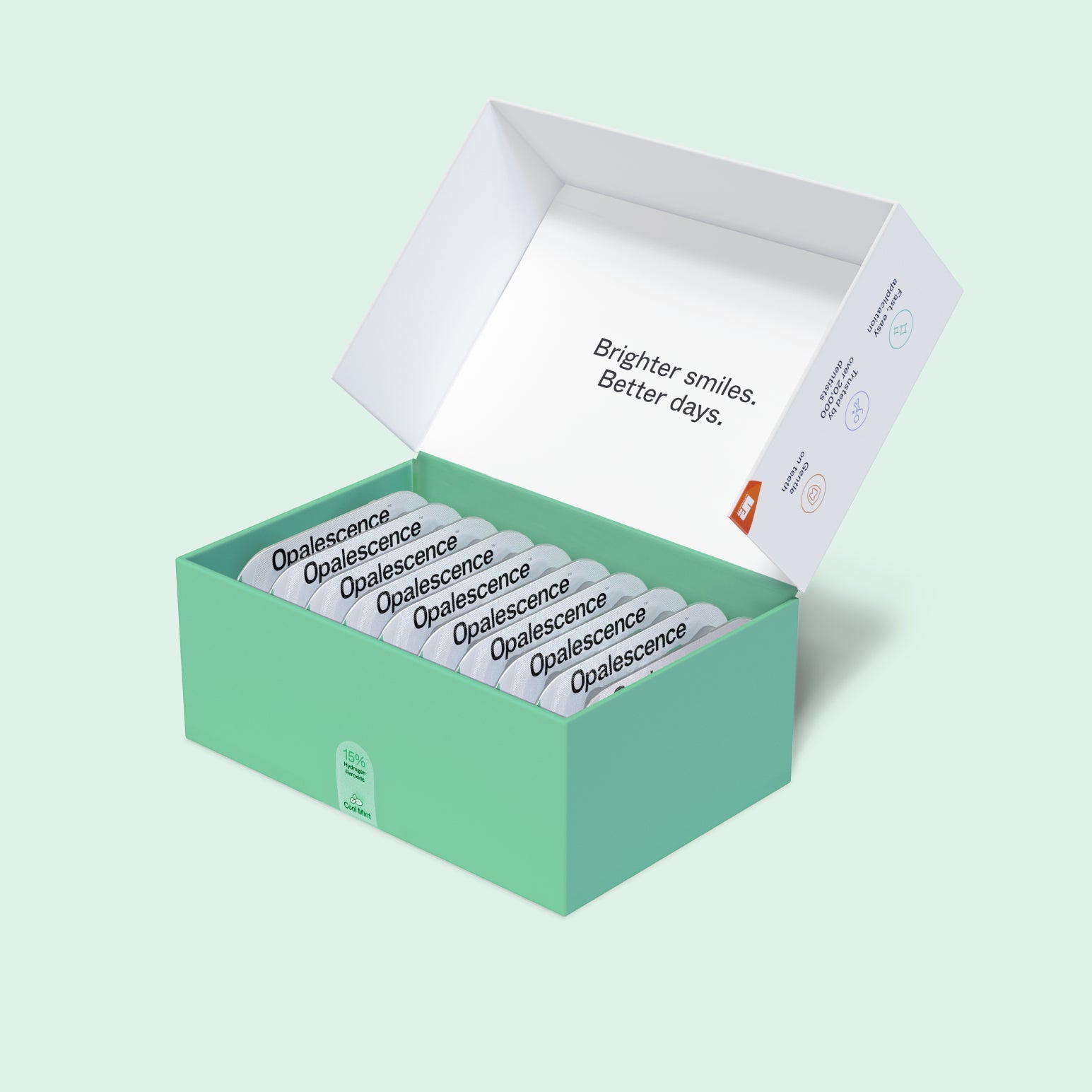 Open Opalescence Go Advanced 15% Prefilled Whitening Trays box with individually packaged whitening trays neatly arranged inside on a light mint green background.