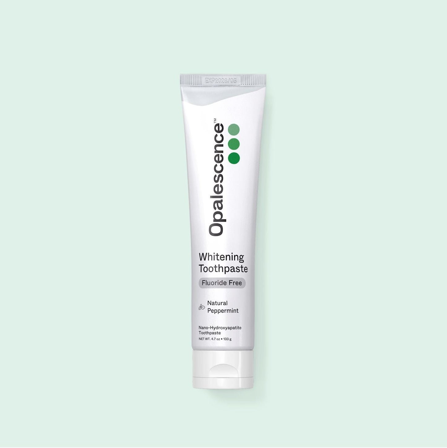 Opalescence whitening toothpaste tube on a light green background
