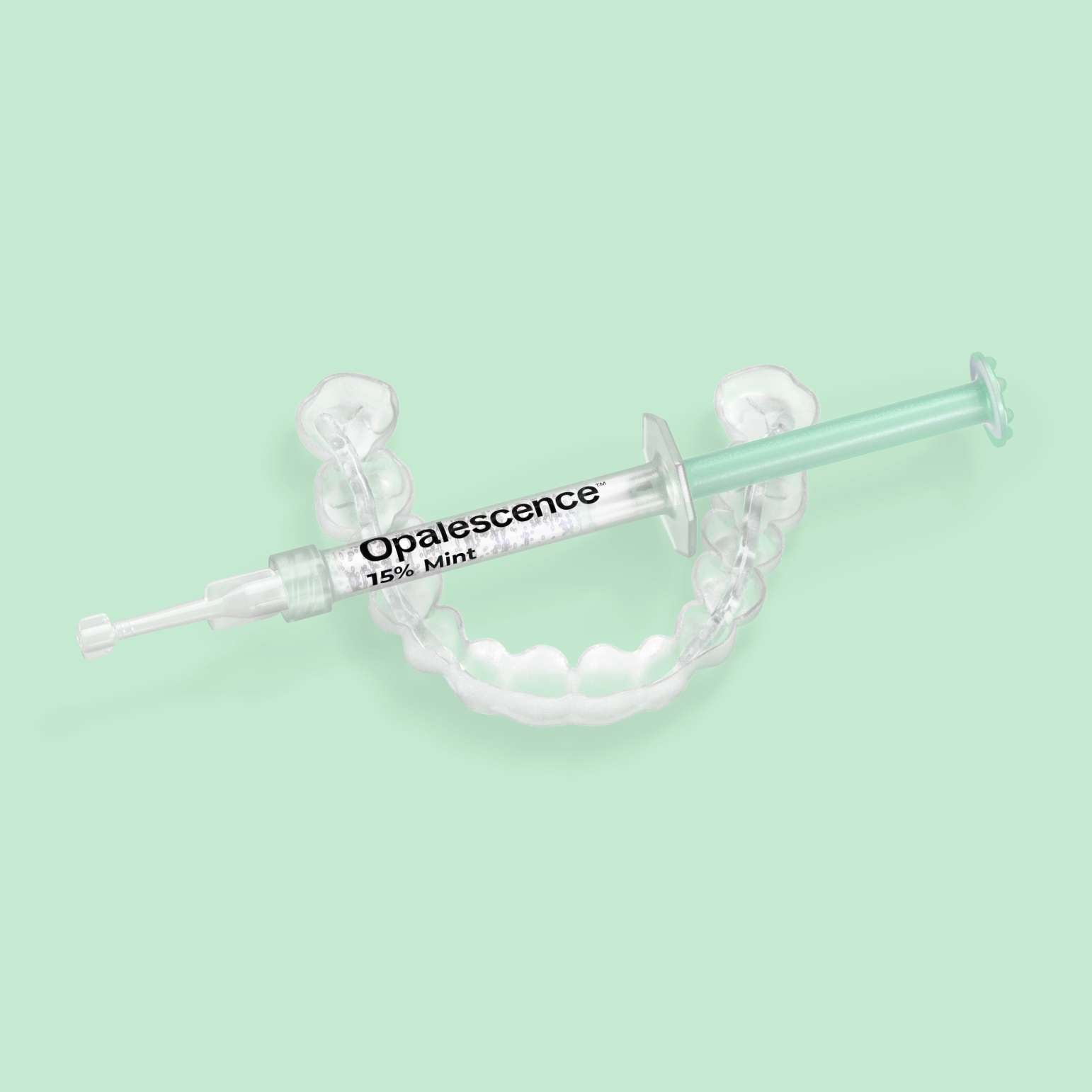 Opalescence 15% Mint syringe resting on a custom teeth whitening tray