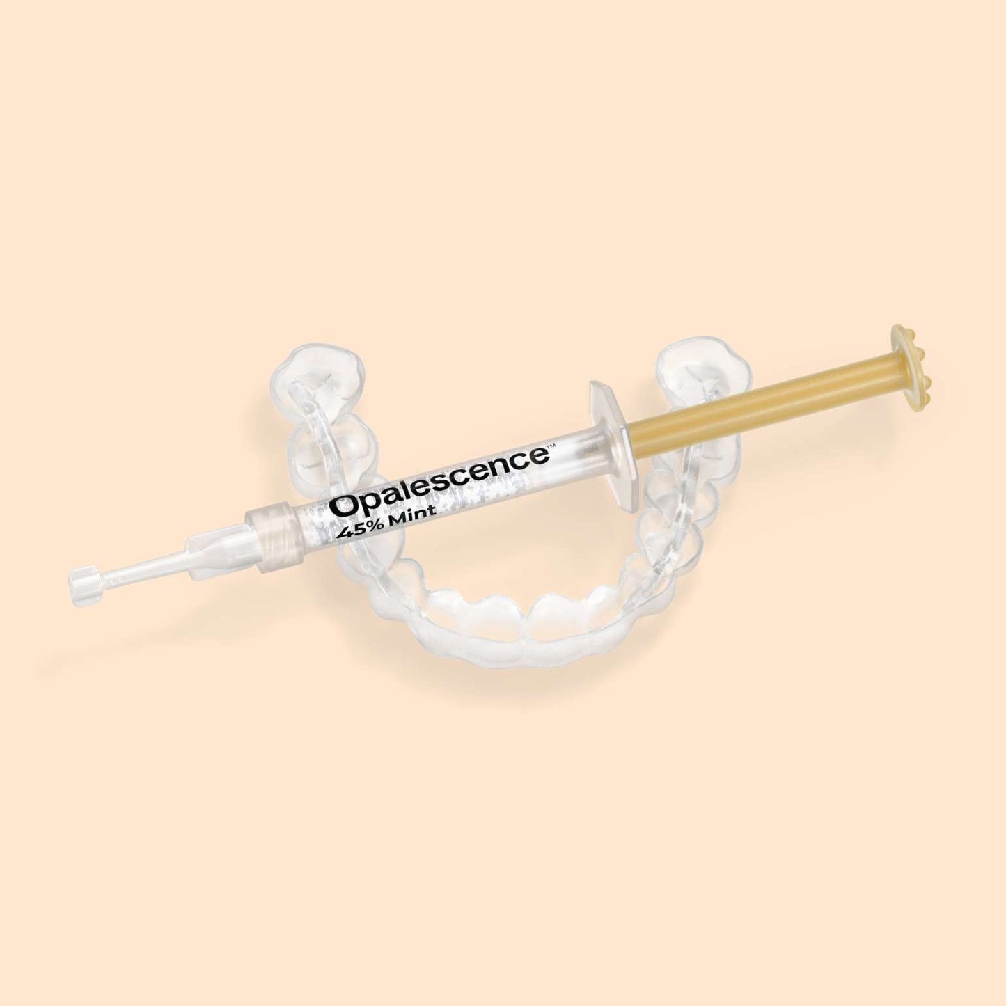 Opalescence 45% Mint syringe resting on a custom teeth whitening tray