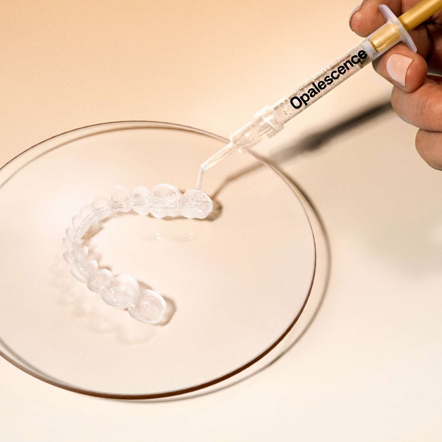 Close up of applying Opalescence 45%  into a custom teeth whitening tray