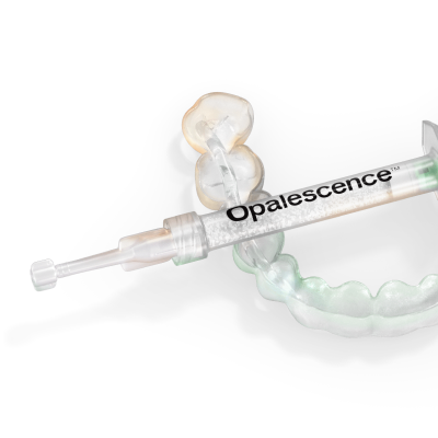 Opalescence teeth whitening gel syringe resting on a dentist-provided custom tray